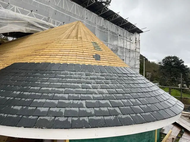 Natural slate going onto a conical turret roof