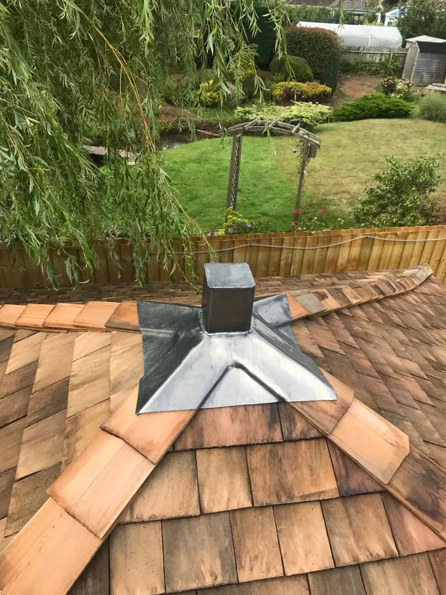 Lead collar dressed around a stack on a cedar shingle roof