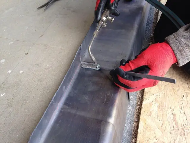 Lead welding a joint in a new lead gutter