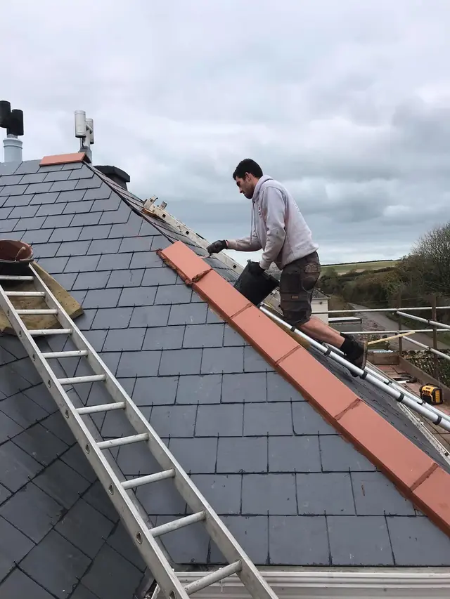 Fixing new ridge tiles on a slate roof