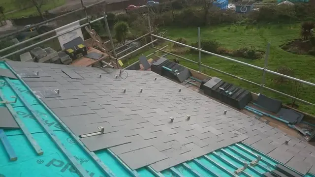 New slates laid over breathable membrane during a re-roof