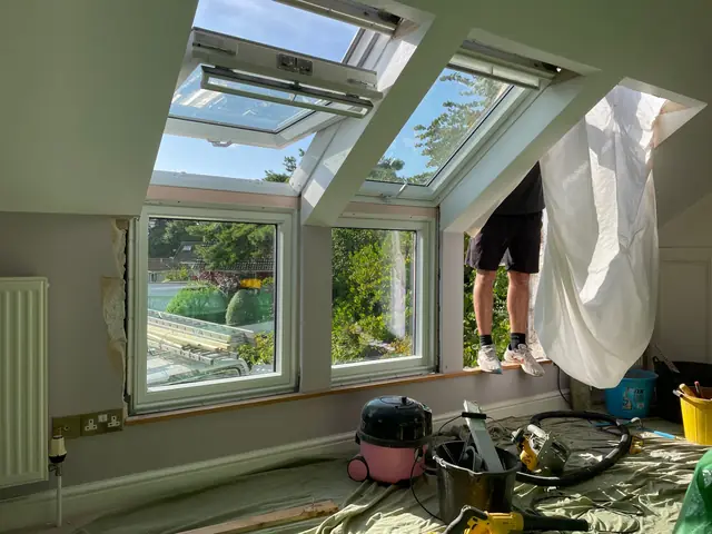 Bright loft room with VELUX roof windows above vertical windows